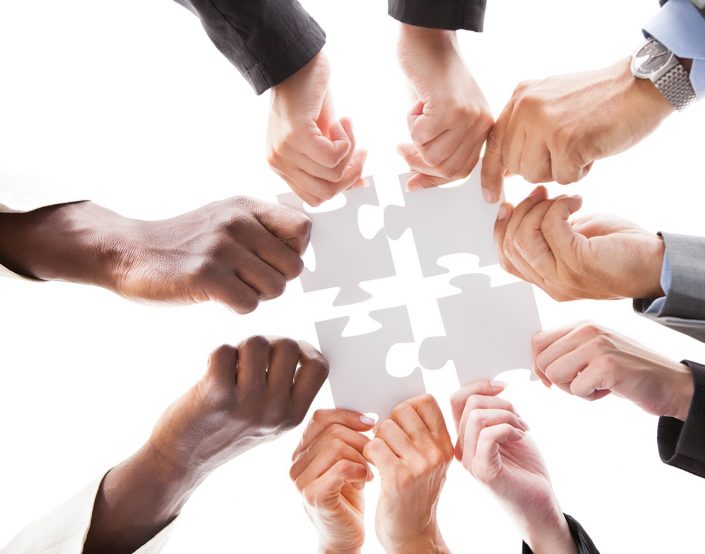 Businesspeople Holding Jigsaw Puzzle finance function